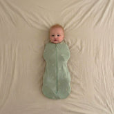 baby wearing 0.2 TOG sleep swaddle sack sage green